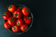 fresh-organic-red-tomatoes-black-plate-close-up-healthy-concept-top-view_114579-1227